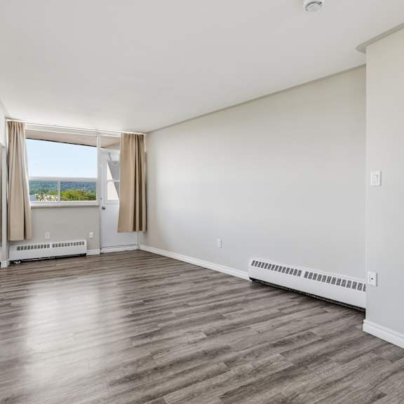 a room with a view of the water through the window.