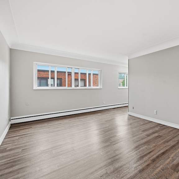 a room with wooden floors and a white door.