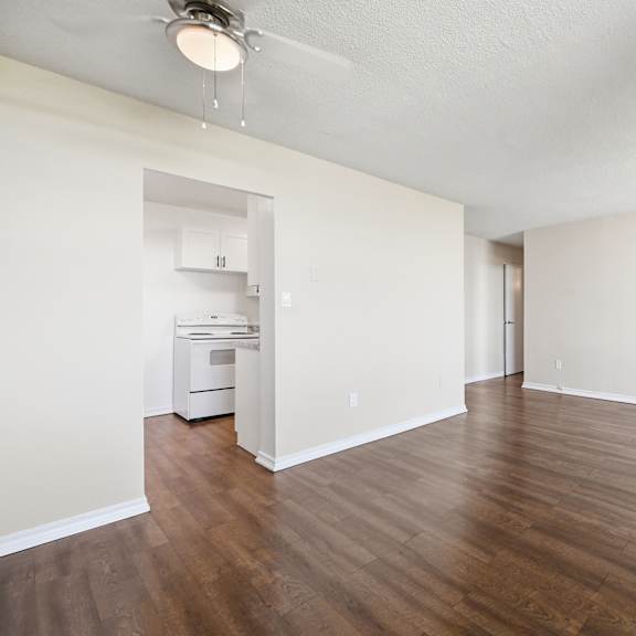 a room with wooden floors and a ceiling fan.