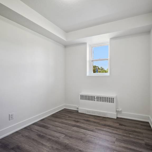 a room with a window and a radiator on the floor.