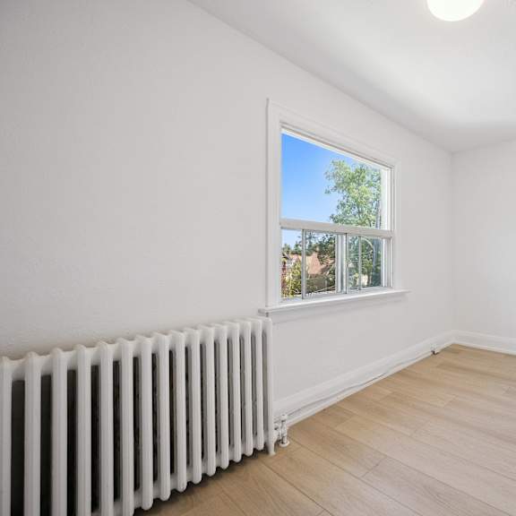 a room with a white wall and a window with a white frame.