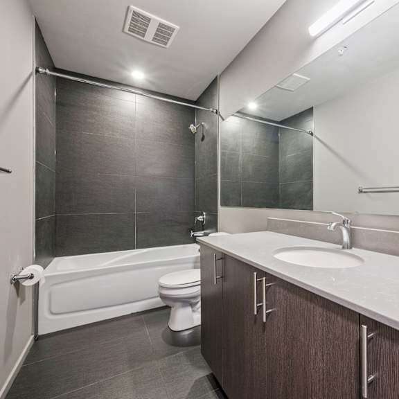 a bathroom with a white toilet and a white sink.