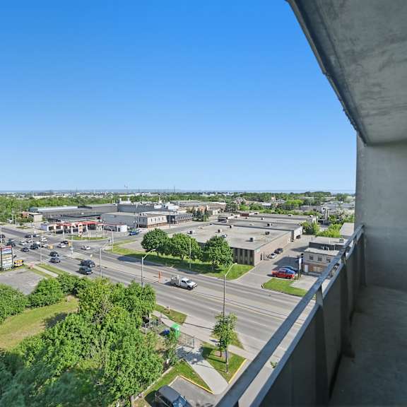 a view from a high vantage point looking down at a busy intersection with cars and buildings.