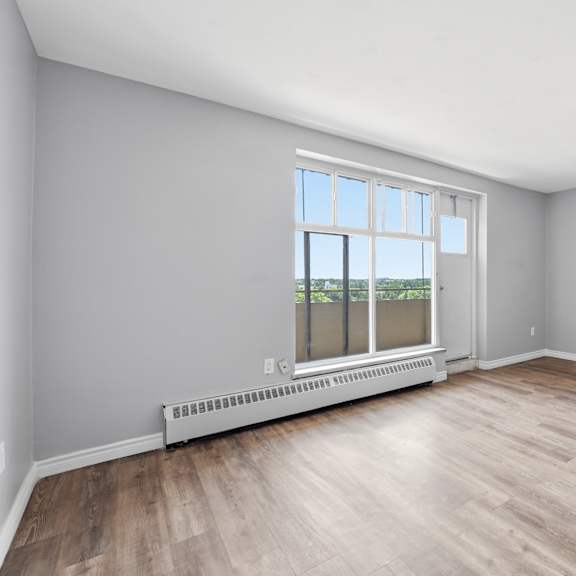 a room with a window and a radiator on the floor.