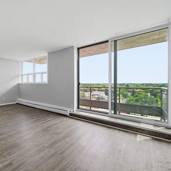 a room with a sliding glass door leading to a balcony.
