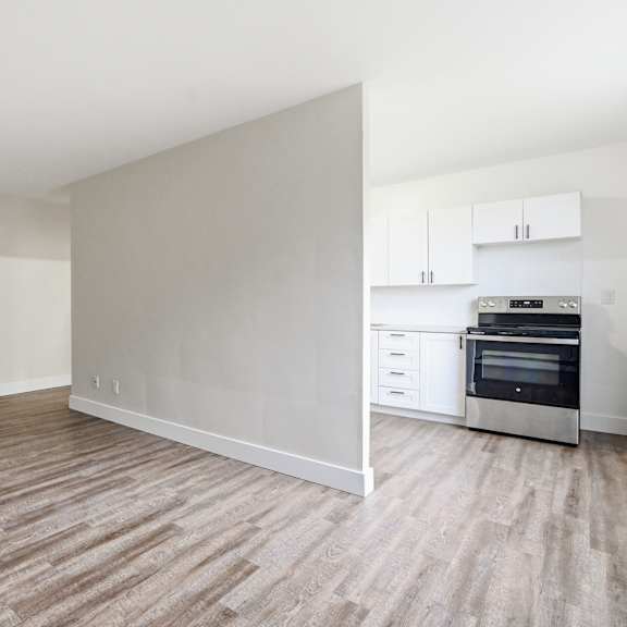 a kitchen with white cabinets and a stove top oven.