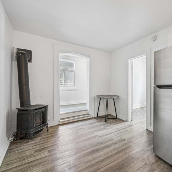 a kitchen with a wood stove and a refrigerator.