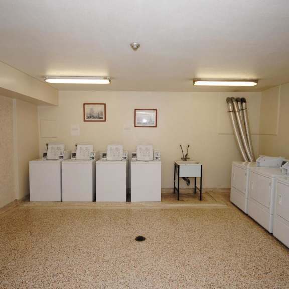 a laundry room with washers and dryers.