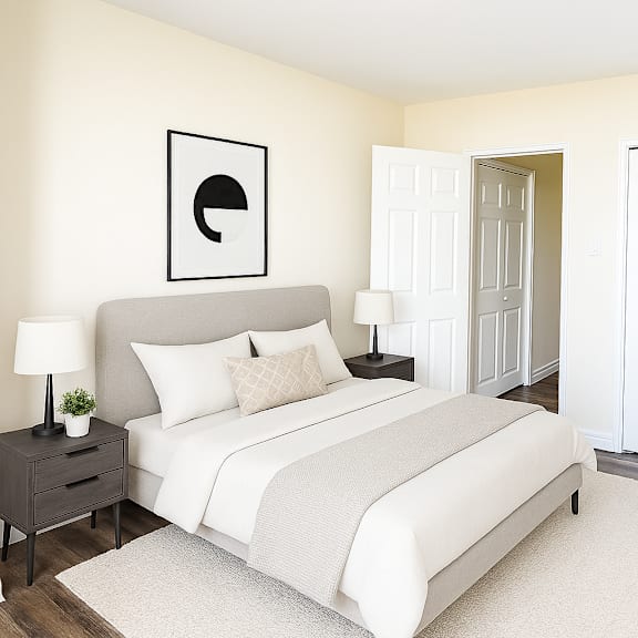 a bedroom with a bed, chair, and a wall art.