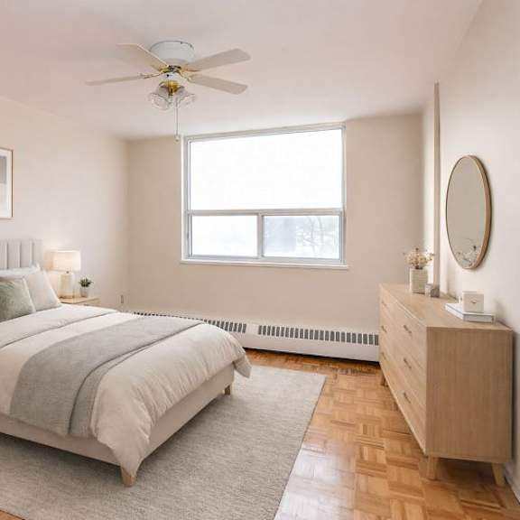 a bedroom with a bed, nightstand, and a window.