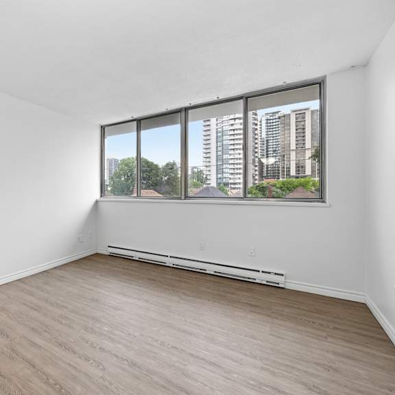 a room with a window overlooking a cityscape.