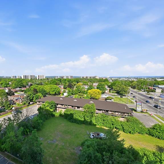 a view of a green field with a building in the background.