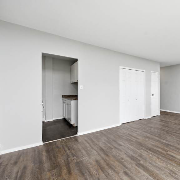 a room with wooden floors and white walls.