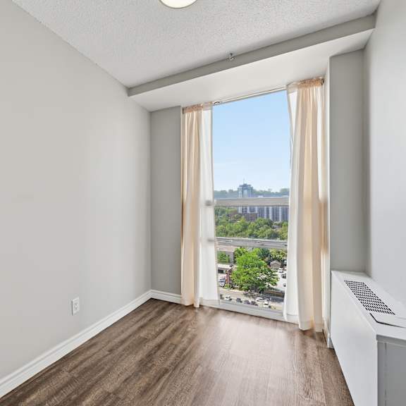 a room with a window overlooking a cityscape.