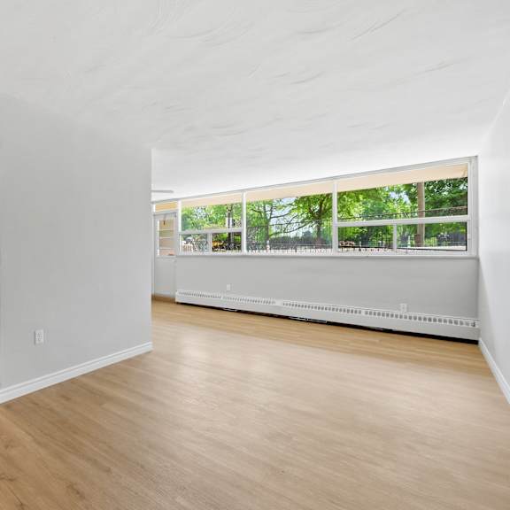 a room with wooden floors and white walls.