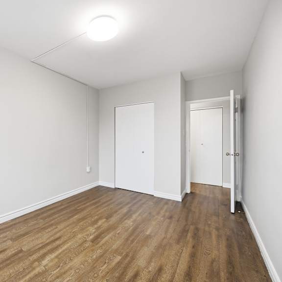 a room with wooden floors and white walls.
