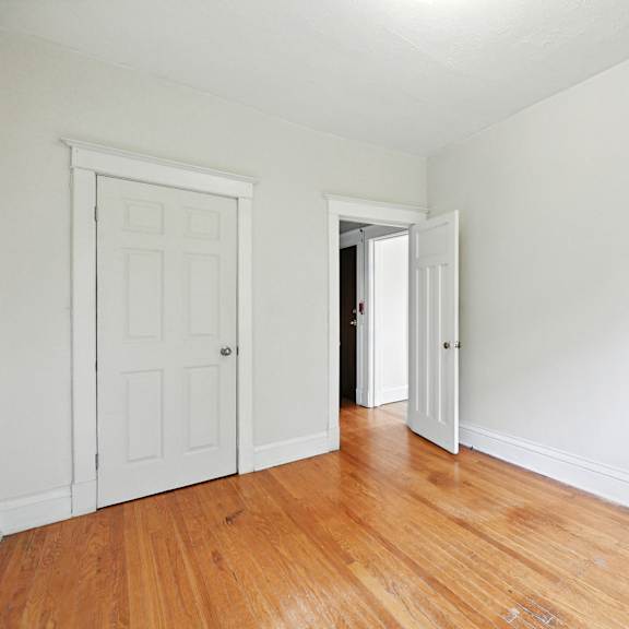 a room with a white door and a white wall.