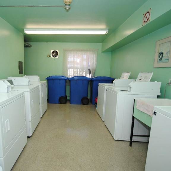 a laundry room with washers and dryers.