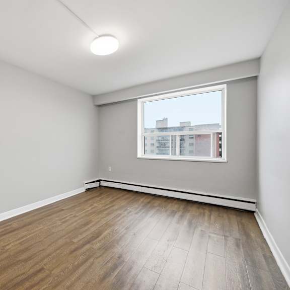 empty room with wooden floor and a window.
