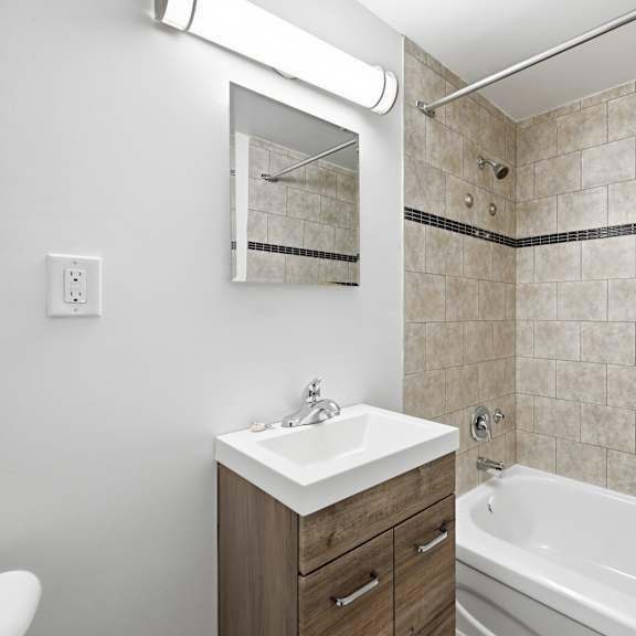 a bathroom with a white sink and a white bathtub.