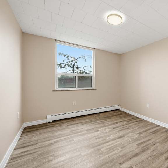 empty room with wooden floor and a window.