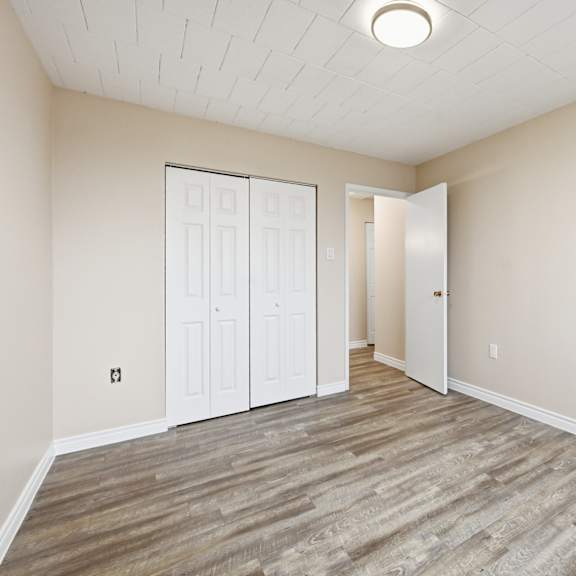 a room with a white ceiling and a wooden floor.
