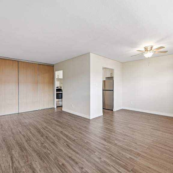 a room with wooden floors and a ceiling fan.