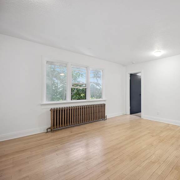 a room with a window and a radiator on the wall.
