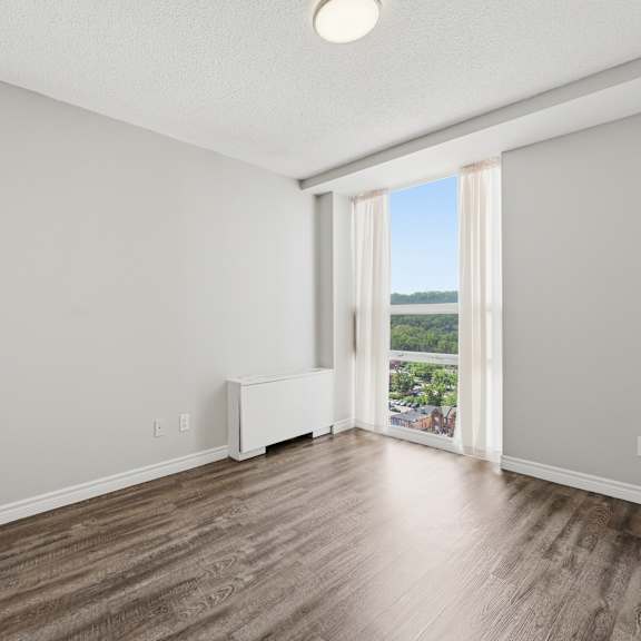 a room with a white sofa and wooden flooring.