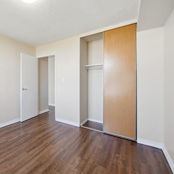 a room with a wooden floor and a brown door.