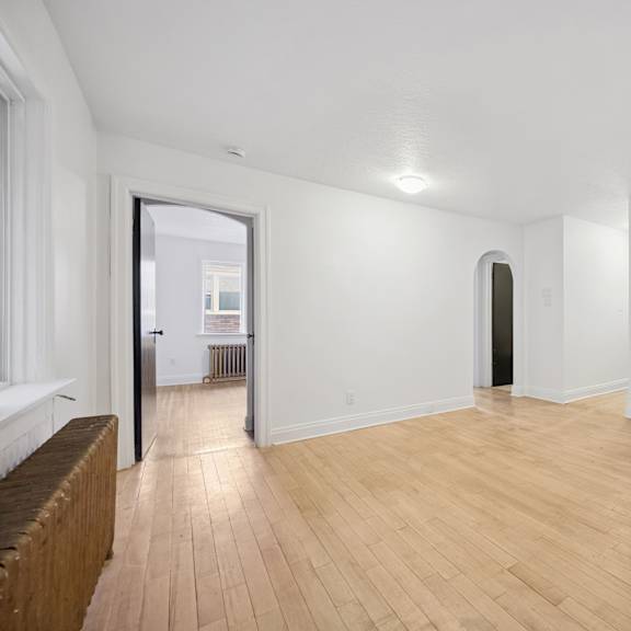 a room with wooden floors and white walls.