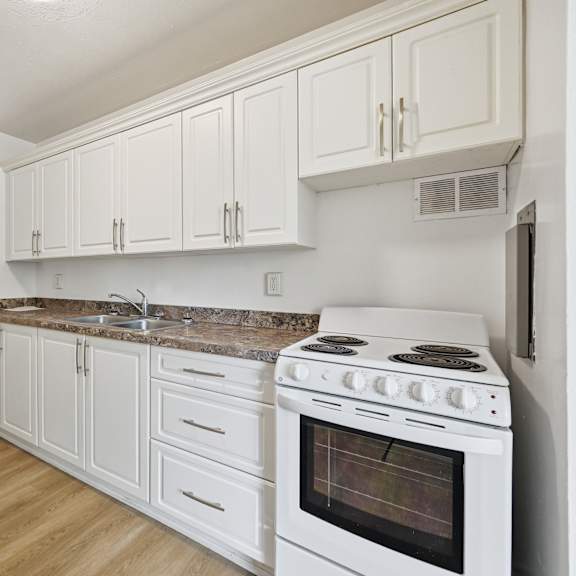 a kitchen with white appliances and cabinets.