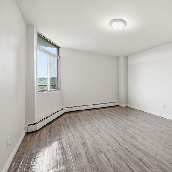 a room with wooden flooring and a window.