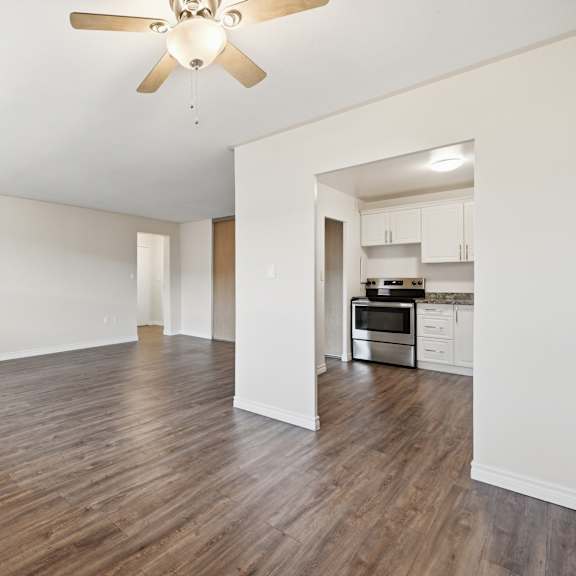 a room with wooden floors and a ceiling fan.