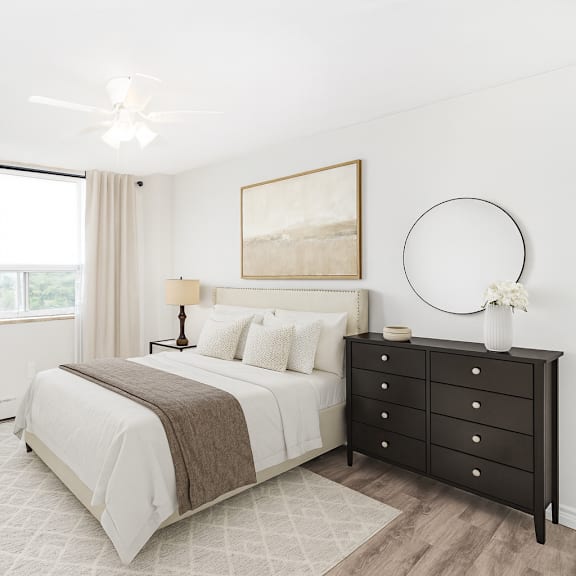 a bedroom with a large bed, a chair, and a painting on the wall.