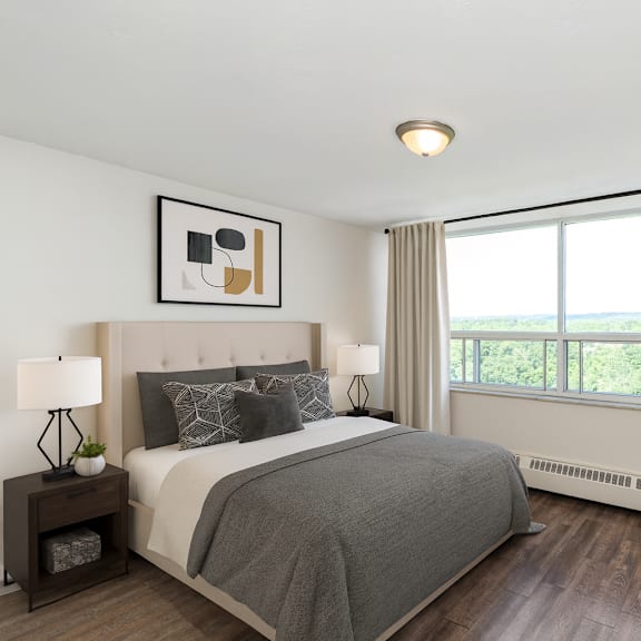 a bedroom with a large bed and a window overlooking the ocean.