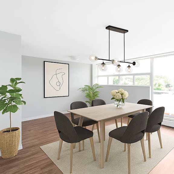 a dining room with a table and chairs.