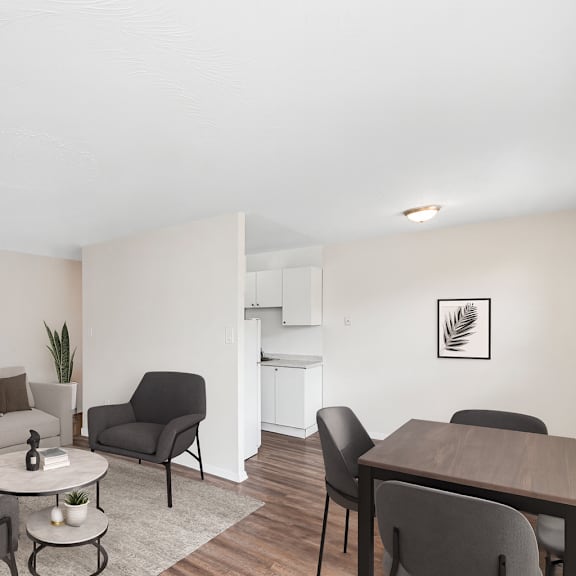 a living room with a grey couch, a white coffee table, and a grey chair.