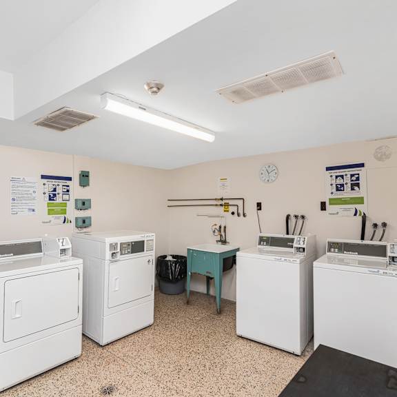 a laundry room with washers and dryers.
