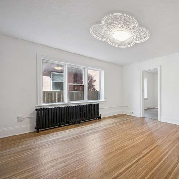 a room with wooden floors and white walls.