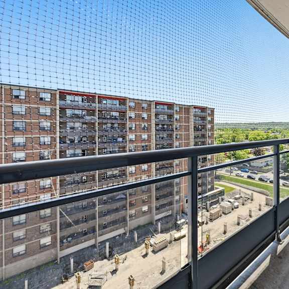 a balcony with a view of a construction site and a building.