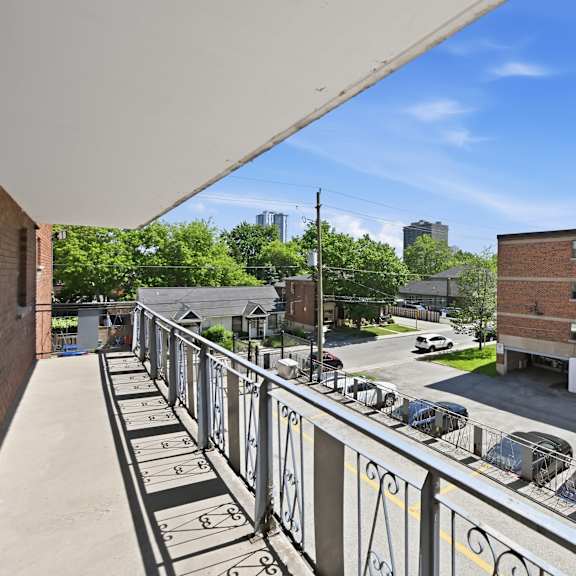 a parking lot with cars and a building in the background.