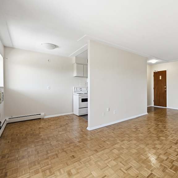 a room with a wooden floor and a door on the right side.