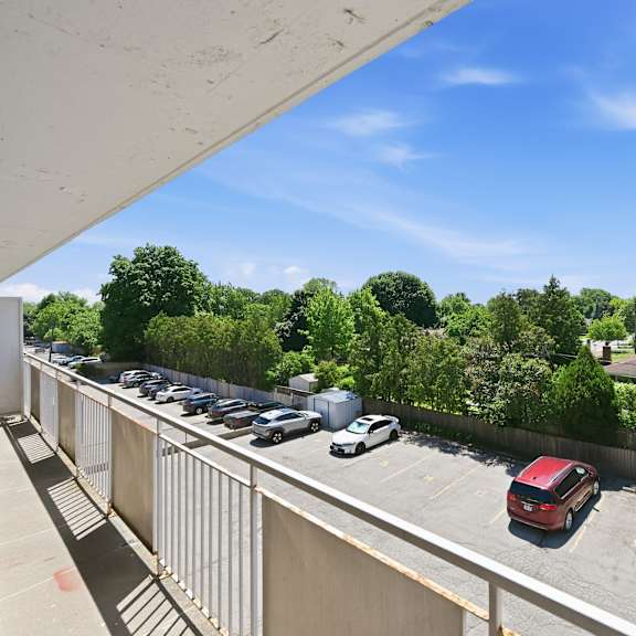a parking lot with cars and a red car in the foreground.
