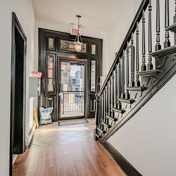 a staircase with a black metal railing and wooden steps.