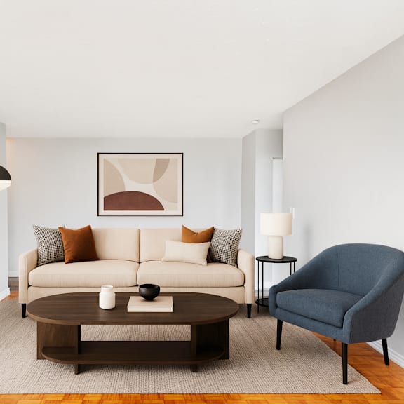 a living room with a white couch, a brown coffee table, a blue armchair, and a brown cabinet.