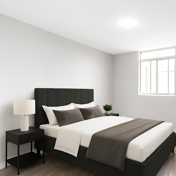 a bedroom with a large bed and a potted plant.