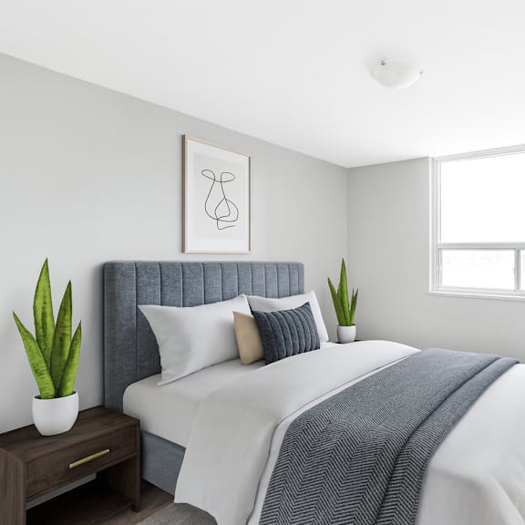 a bedroom with a bed, pillows, a blanket, a nightstand, and a window.