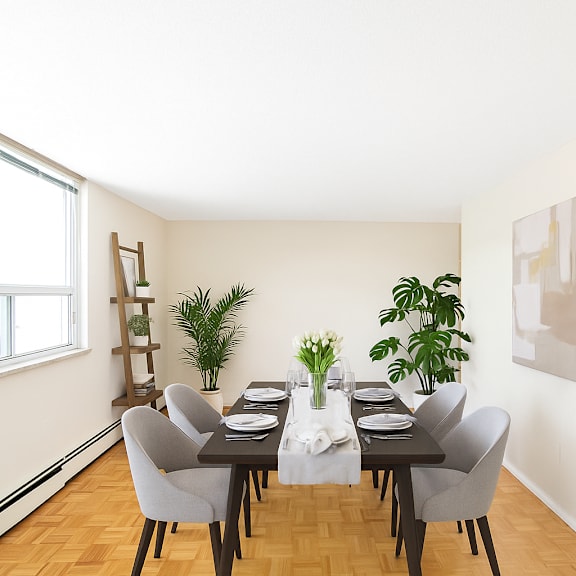 a dining room with a table set for two and a potted plant on the table.