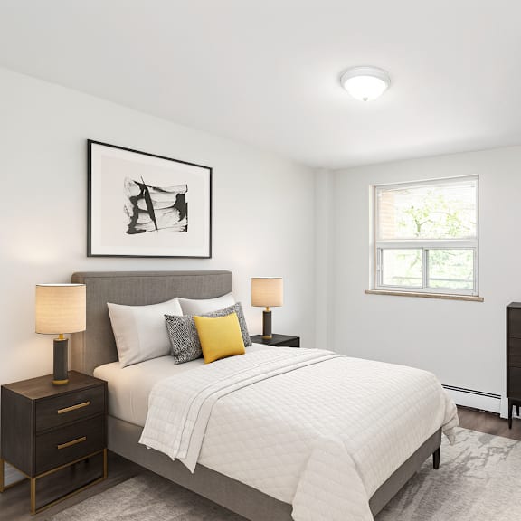 a bedroom with a bed, chair, and a picture on the wall.